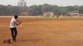 A batsman playing game of cricket. Children enjoying various sports on the playground.