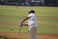 A fat man is playing cricket in his free time. Royalty Free Stock Photo