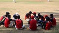 A group of football players sitting in a circle. Royalty Free Stock Photo