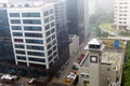 Mumbai rains through the window overlooking office buildings, apartments and roads