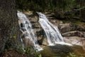 Mumlavsky vodopad waterfall in Krkonose Giant Mountains and Certova oka geological formation in the Mumlava river behind tree Royalty Free Stock Photo