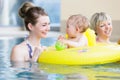 Mothers and kids having fun together playing with toys in pool Royalty Free Stock Photo