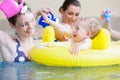 Mothers and kids having fun together playing with toys in pool Royalty Free Stock Photo