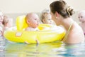 Mothers and kids having fun together playing with toys in pool Royalty Free Stock Photo