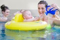 Mothers and kids having fun together playing with toys in pool Royalty Free Stock Photo