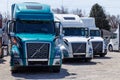 Colorful Volvo Semi Tractor Trailer Trucks Lined up for Sale. Volvo is one of the largest truck manufacturers IV