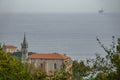 Mundaka church with gas ocean platform in the horizon Royalty Free Stock Photo