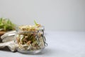 Mung bean sprouts in glass jar on white table, closeup. Space for text Royalty Free Stock Photo
