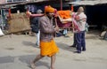 Brightly dressed religious pilgrims walk alongside the road in rural India.