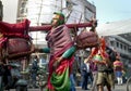 Brightly dressed religious pilgrims walk alongside the road in rural India.