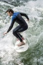 MUNICH - AUGUST 08: An unidentified male surfer works the wave at Eisbach Royalty Free Stock Photo