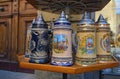 Close-up view of beautiful decorated ceramic beer cups in souvenir shop