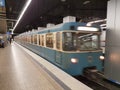 MUNICH, GERMANY - APRIL 2, 2020: A photo of a old subway train arriving to a deserted  Main Trainstation station in Munich Royalty Free Stock Photo