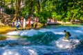 MUNICH, GERMANY, AUGUST 20, 2015: group of surfers is practicing their skill on an artificial wave situated on a small Royalty Free Stock Photo