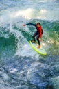 MUNICH, GERMANY, AUGUST 20, 2015: group of surfers is practicing their skill on an artificial wave situated on a small Royalty Free Stock Photo