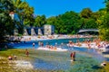 MUNICH, GERMANY, AUGUST 20, 2015: People enjoy sunny hot weather on the river banks of Isar river in bavarian city