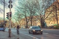 Munich, Germany, December 29, 2016: A car and a bicyclist stand at a traffic light in Munich. City life. Everyday life