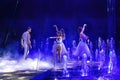 Gymnasts dancing in white costumes and dresses in the circus arena. A group of dancers Royalty Free Stock Photo