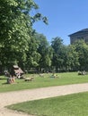 Munich, Germany - July 1, 2018: People sunbathing in the grass in front of Alte Pinakothek