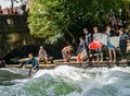 Surfer on the Eisbach in the English Garden with many spectactors