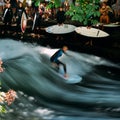 Surfer on the Eisbach in the English Garden with many spectactors