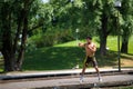 MUNICH, GERMANY - Jun 01, 2020: Strong athletic young man performs boxing exercises in a park