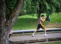 MUNICH, GERMANY - Jun 01, 2020: Strong athletic young man performs boxing exercises in a park