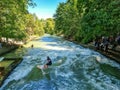 Munich, Germany - 22 June 2024: Surfer at the Eisbach wave in the centre of Munich on the Isar river Royalty Free Stock Photo