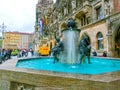 Munich, Germany - May 01, 2017: People sitting on the edge of Fish Fountain with New Town Hall in the background at Royalty Free Stock Photo