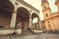 Busy square Odeonsplatz with historical loggia Feldherrnhalle and tourists