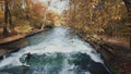 MUNICH, GERMANY, November 18, 2019: Real time shot of Urban Surfers on a wave on the Eisbach river. River Surfing in