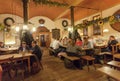 Women and men eating and drinking beer inside traditional restaurant in old Bavarian style Royalty Free Stock Photo