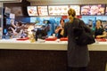 The girl receives an order in the interior of the McDonald`s, Mu