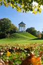 MUNICH, GERMANY - OCTOBER 11, 2017: Monopteros building in the English Garden in Munich in autumn. People sitting at the base of Royalty Free Stock Photo