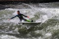 Munich, Germany - October 13, 2023: Surfer in the city river called Eisbach at Munich, Germany