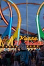 Munich, Germany - September 24: a father is carrying his young son on his shoulders in front of a 5 loop roller coaster on the Royalty Free Stock Photo