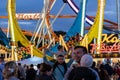 Munich, Germany - September 24: a father is carrying his young son on his shoulders in front of a 5 loop roller coaster on the Royalty Free Stock Photo