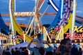 Munich, Germany - September 24: a father is carrying his young son on his shoulders in front of a 5 loop roller coaster on the Royalty Free Stock Photo