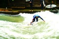 River surfers on Eisbach River in middle of European city. Royalty Free Stock Photo