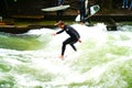 River surfers on Eisbach River in middle of European city. Royalty Free Stock Photo