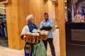 MUNICH, GERMANY - SEPTEMBER 17, 2016: Waitress carrying many beer glasses at the Oktoberfest in Muni