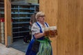 MUNICH, GERMANY - SEPTEMBER 17, 2016: Waitress carrying many beer glasses at the Oktoberfest in Muni