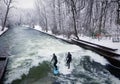 Munich, surfers on Eisbach river in winter Royalty Free Stock Photo