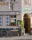 Munich, Germany - waitress prepares tables in open air restauran