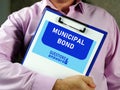 MUNICIPAL BOND text in search line. Modern Banker looking at smartphone