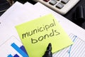 Municipal bond written on a memo stick and documents