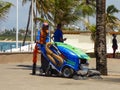 Municipal employee cleaning the streets of Itapua with an electrical sweeper