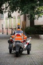 Municipal employee wearing orange vest working in the street