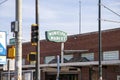 The Municipal Market in a red brick building with a green and white sign, traffic signals and cars driving on the street Royalty Free Stock Photo