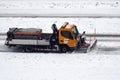 Municipal snowplow at work on snowy streets and roads Royalty Free Stock Photo